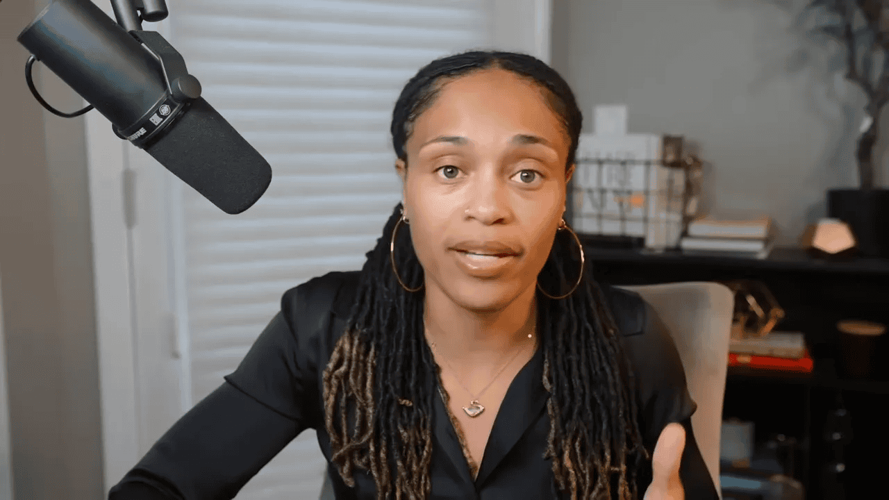 Presenter facing camera with clear expression and studio microphone, discussing utility-driven adoption and liquidity