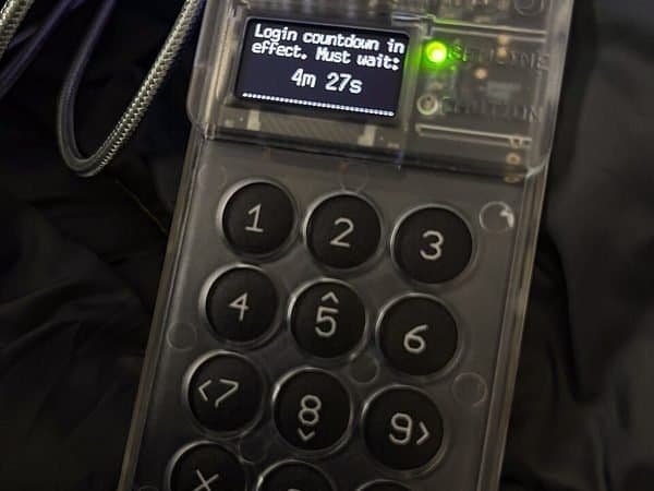 Hardware wallet with a screen and keypad (item type photo, not the exact product)