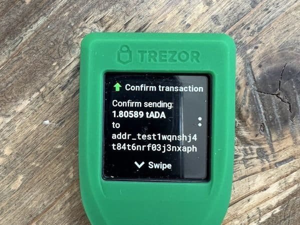 Touchscreen hardware wallet confirming a transaction (item type photo, not the exact product)