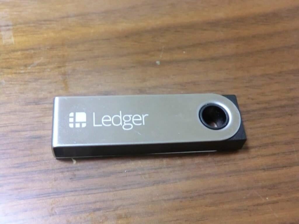 Ledger hardware wallet lying on a wooden table