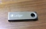 Ledger hardware wallet lying on a wooden table