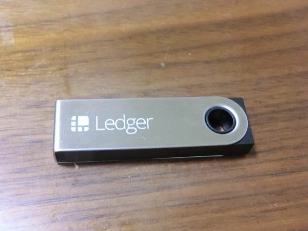 Ledger hardware wallet lying on a wooden table