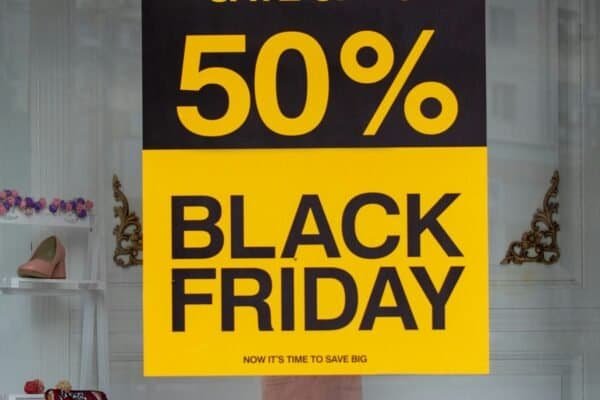 Yellow and black "50% Black Friday" sale sign in a shop window