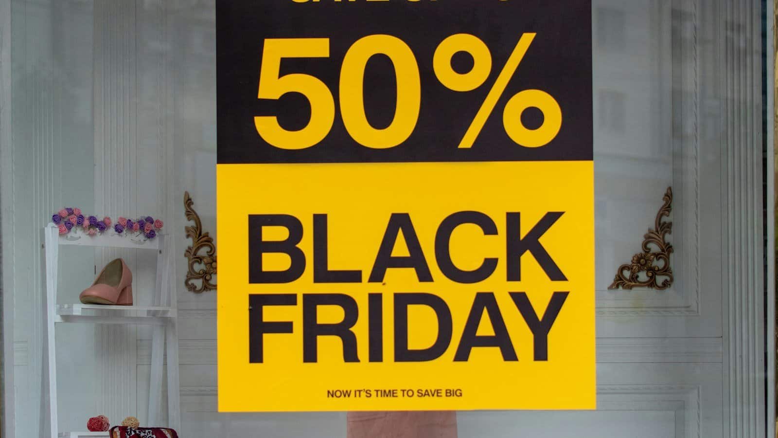 Yellow and black "50% Black Friday" sale sign in a shop window